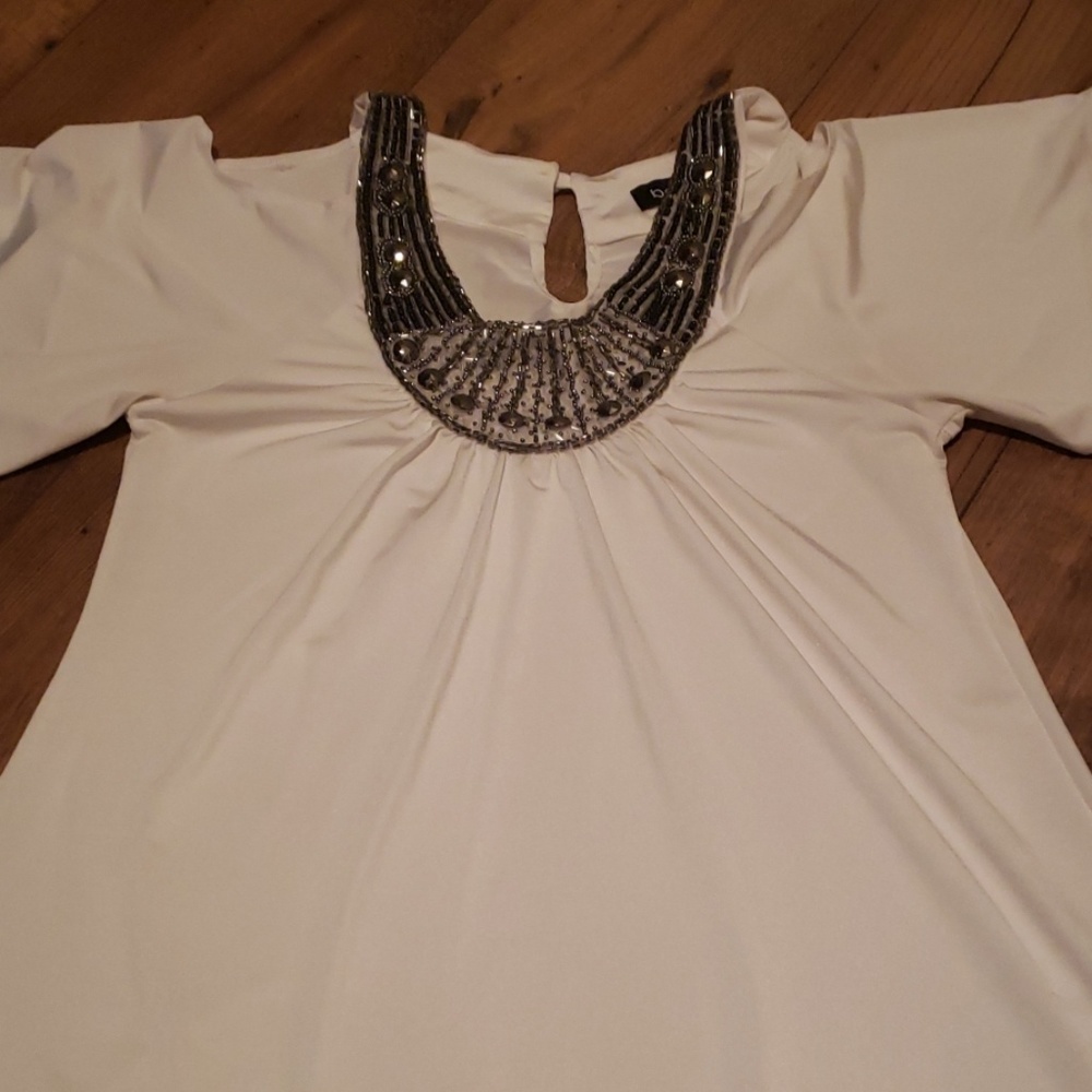 Off white with silver bling. Cut out shoulders.